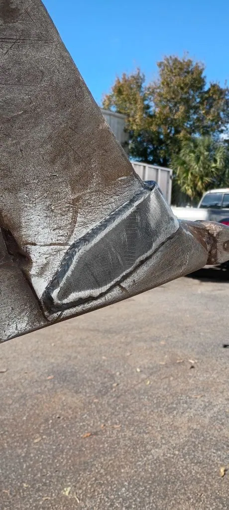 Reinforced corner on a heavy equipment bucket, fresh welds around the new plate