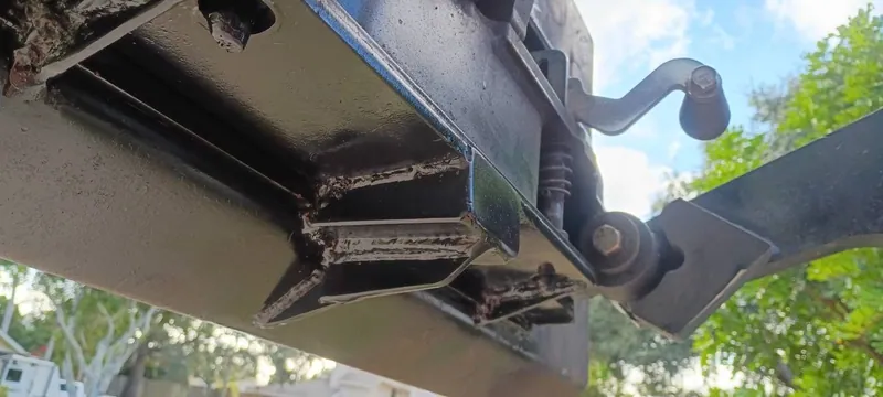 Welded gusset reinforcements under a black painted steel frame