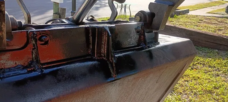 Black painted welded steel assembly with the weld seams visible under the gloss