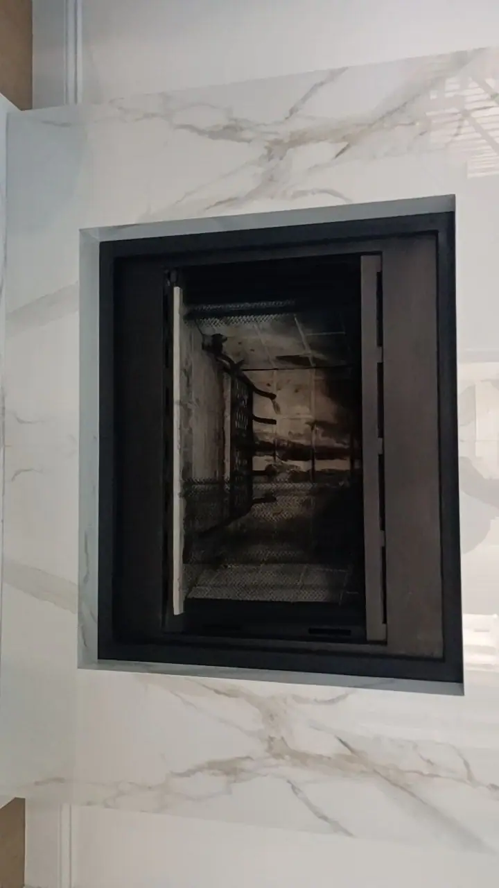 Custom steel frame set into a marble feature wall