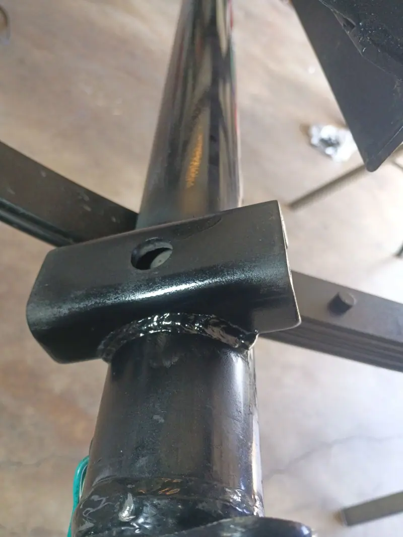 Welded bracket on a black steel tube